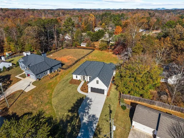 an aerial view of residential houses with outdoor space