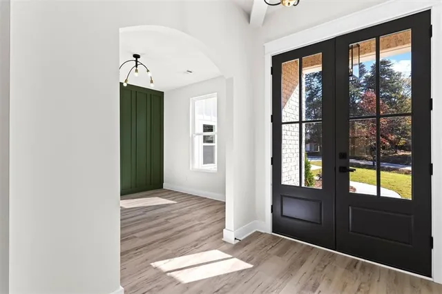 an empty room with a window and wooden floor