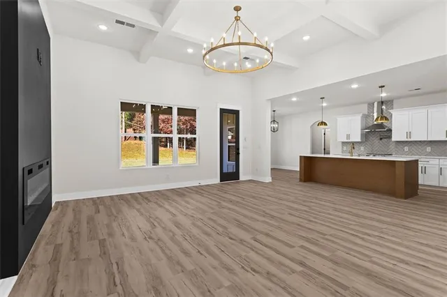 a view of hallway with closet and wooden floor