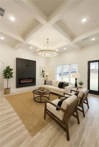 a view of a hallway with wooden floor and entryway