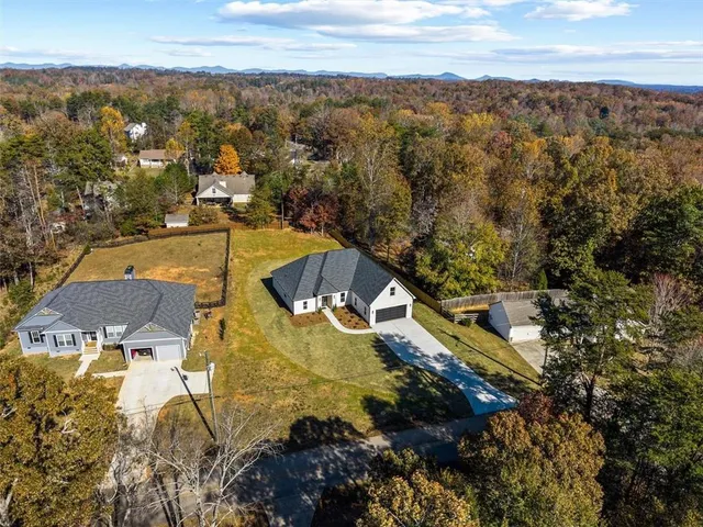 an aerial view of a house with swimming pool and sitting area