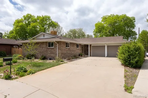 a front view of a house with yard and green space