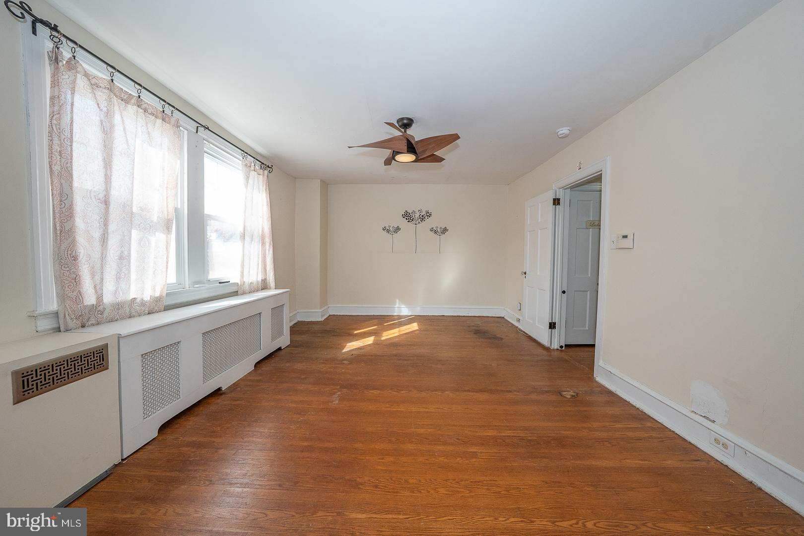 2939 Berkley Road Ardmore, PA 19003 - Photo 18 of 37 wooden floor in an empty room with a window