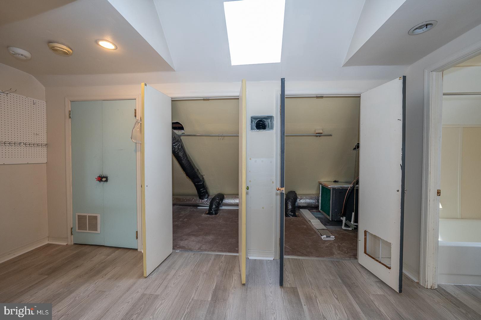 2939 Berkley Road Ardmore, PA 19003 - Photo 29 of 37 a view of a hallway with wooden floor and a livingroom with furniture