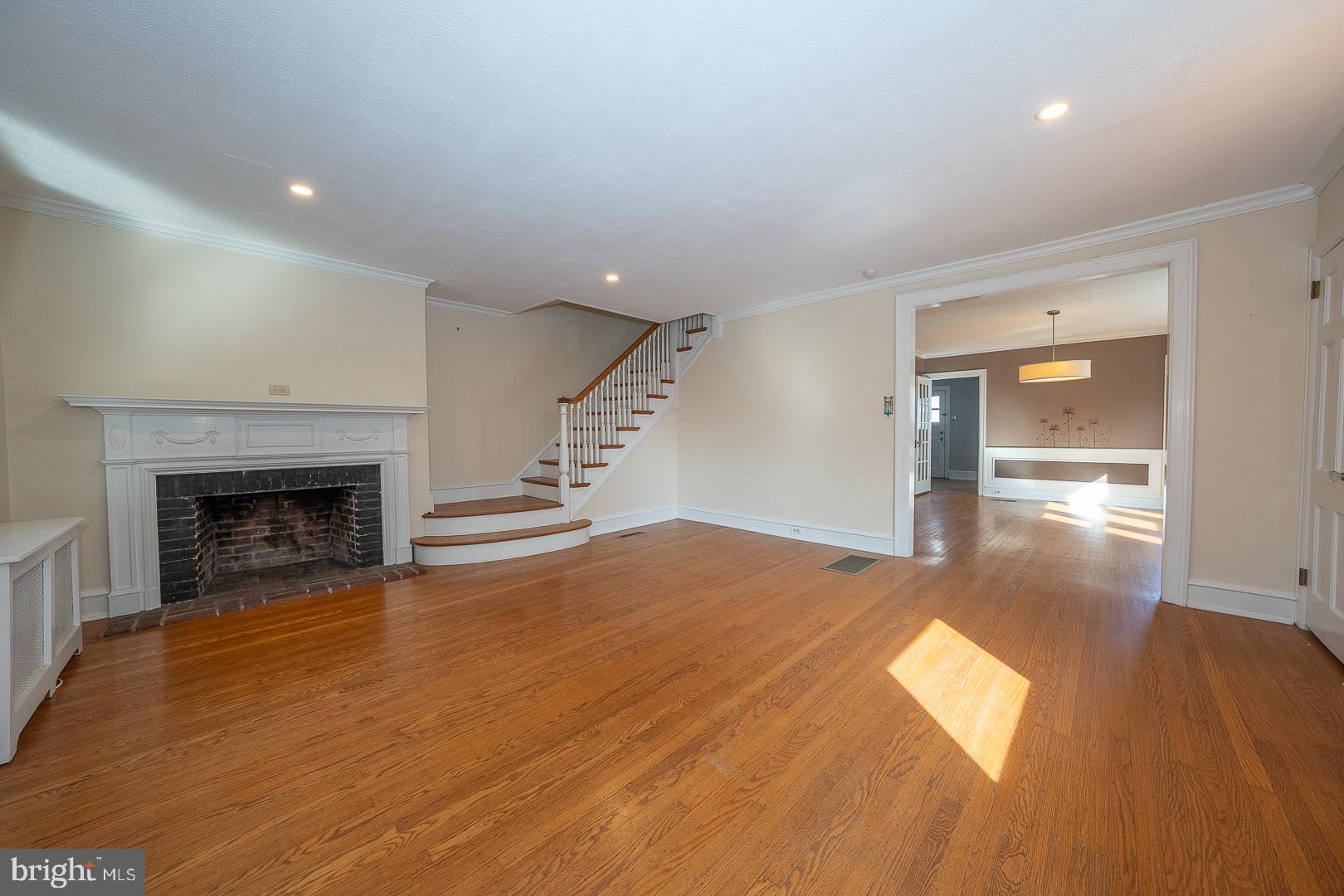 2939 Berkley Road Ardmore, PA 19003 - Photo 4 of 37 a view of empty room with wooden floor and fireplace