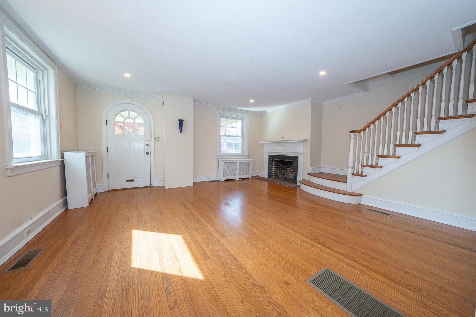 2939 Berkley Road Ardmore, PA 19003 - Photo 5 of 37 a view of empty room with wooden floor and fireplace