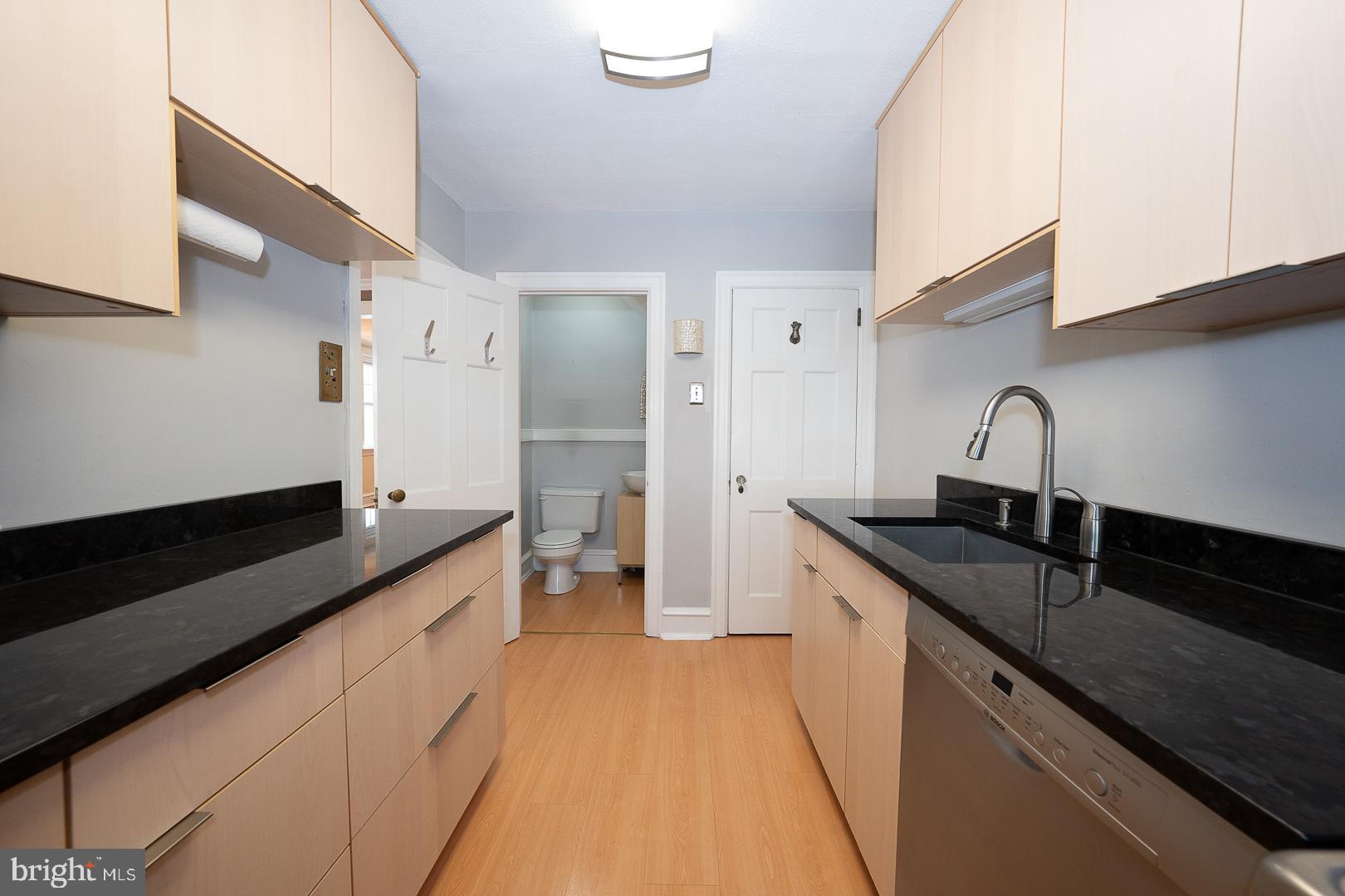 2939 Berkley Road Ardmore, PA 19003 - Photo 9 of 37 a kitchen with granite countertop sink a stove and cabinets