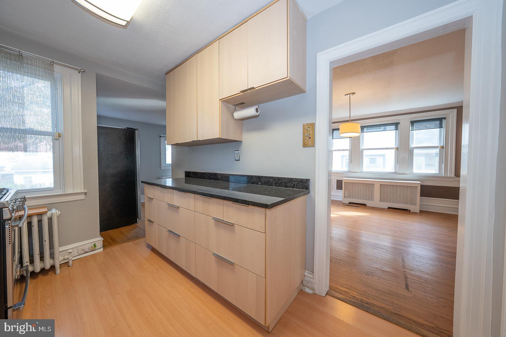 2939 Berkley Road Ardmore, PA 19003 - Photo 10 of 37 a kitchen with granite countertop a stove and a view of living room