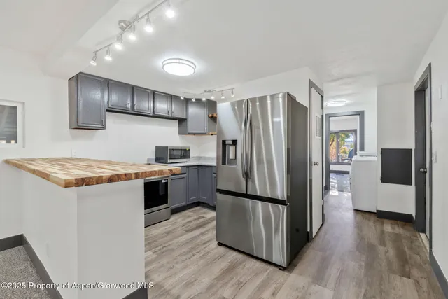 a kitchen with a refrigerator and a sink