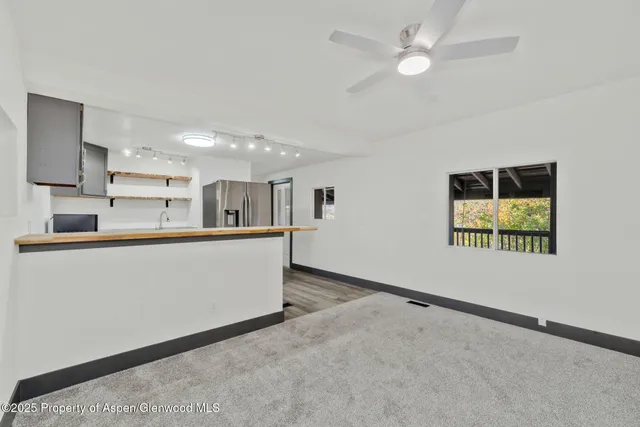 a view of kitchen with furniture and ceiling fan