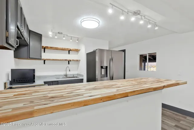 a kitchen with stainless steel appliances granite countertop a sink and a stove