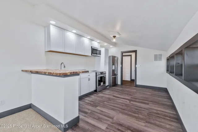 a kitchen with a sink and a refrigerator