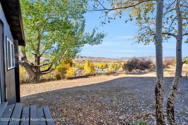 a view of a house with a tree in the background