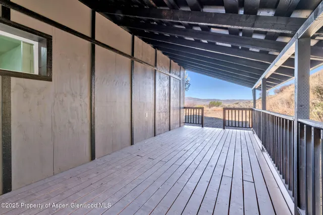 a view of backyard with a wooden deck