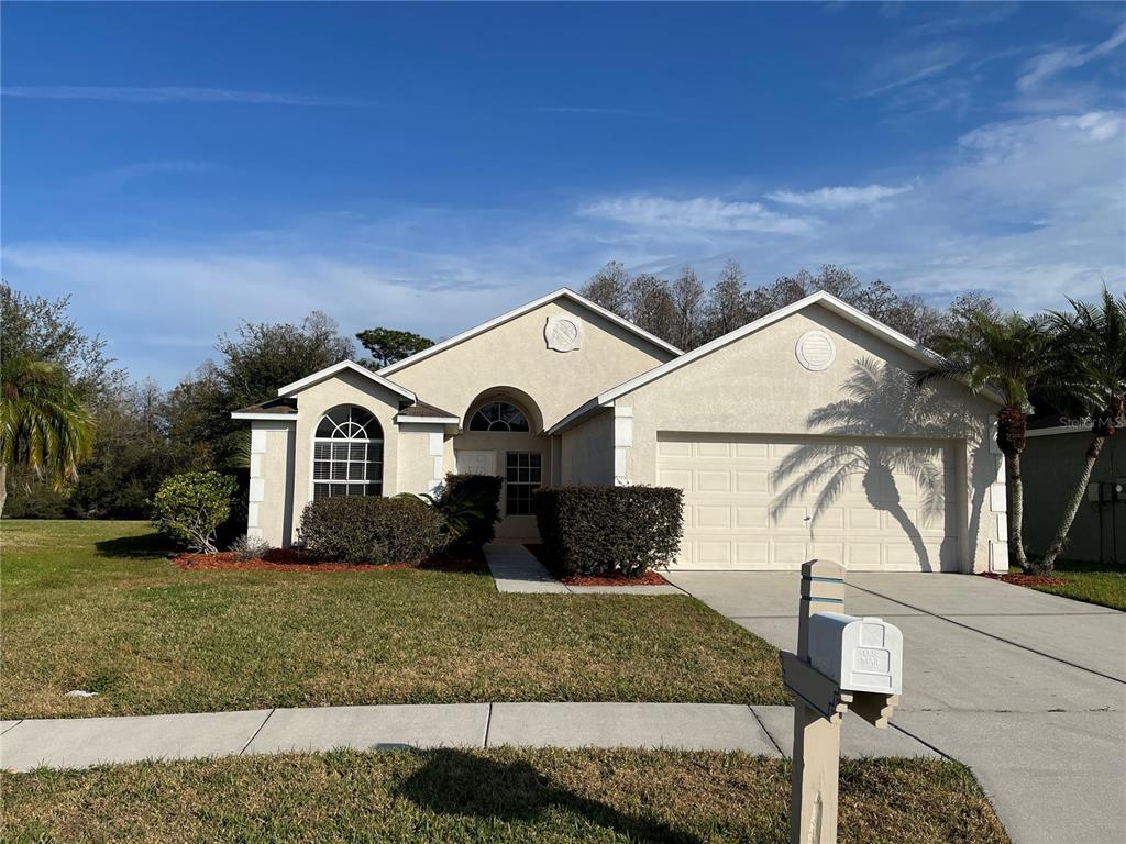 1930 Grenville Court Wesley Chapel, FL 33543 - Photo 1 of 18 a front view of a house with a yard