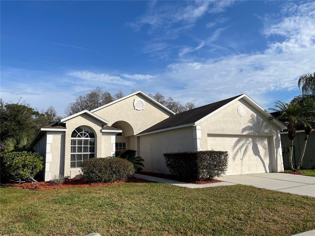 1930 Grenville Court Wesley Chapel, FL 33543 - Photo 2 of 18 a front view of a house with a yard