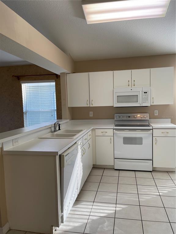 1930 Grenville Court Wesley Chapel, FL 33543 - Photo 6 of 18 a kitchen with a stove sink and cabinets