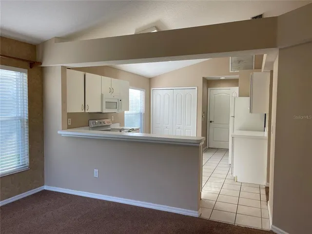 a kitchen with stainless steel appliances a sink stove and cabinets