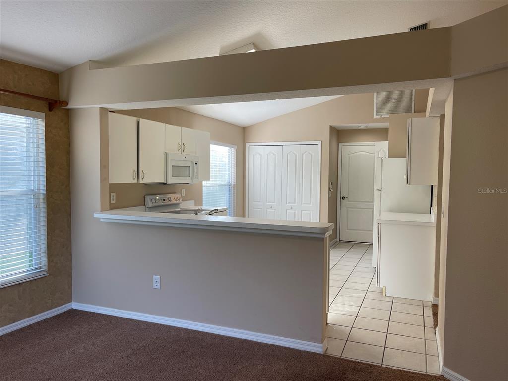 1930 Grenville Court Wesley Chapel, FL 33543 - Photo 7 of 18 a kitchen with stainless steel appliances a sink stove and cabinets