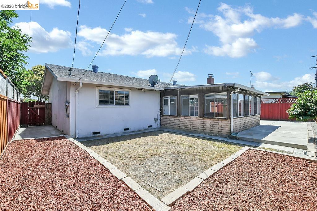 805 Calero Street Milpitas, CA 95035 - Photo 20 of 23 Rear exterior featuring a sunroom addition with a brick veneer base