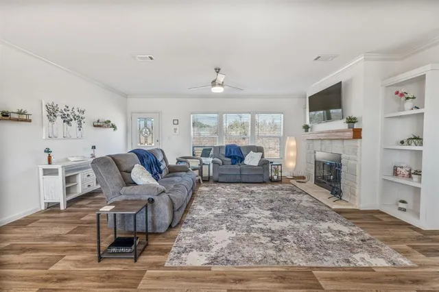 a living room with furniture fireplace and flat screen tv