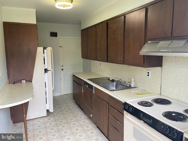 7228 Lanark Road Baltimore, MD 21212 - Photo 3 of 16 a kitchen with a sink a stove and a refrigerator