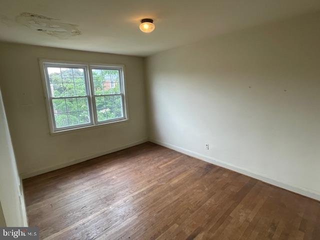 7228 Lanark Road Baltimore, MD 21212 - Photo 6 of 16 an empty room with wooden floor and windows