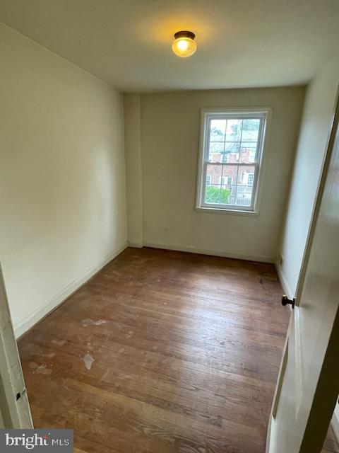 7228 Lanark Road Baltimore, MD 21212 - Photo 8 of 16 an empty room with wooden floor and windows