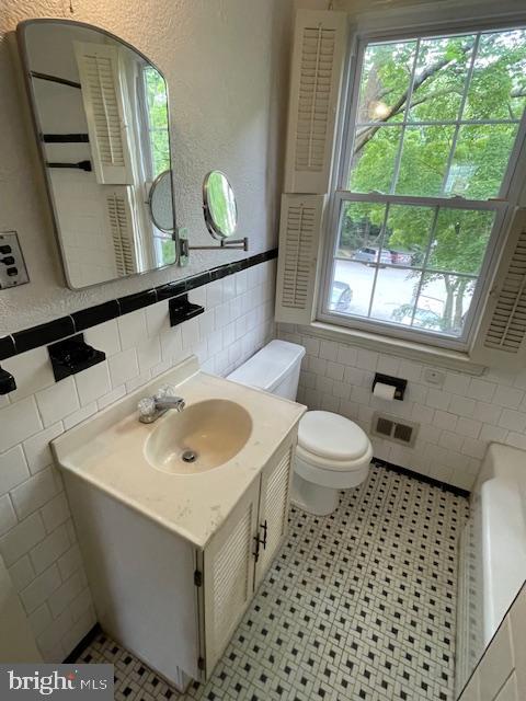 7228 Lanark Road Baltimore, MD 21212 - Photo 10 of 16 a bathroom with a sink toilet and mirror