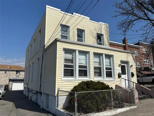 a front view of a house with iron fence