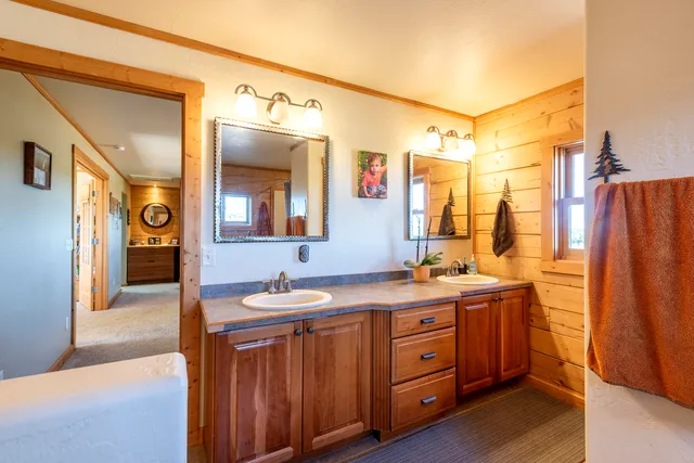a spacious bathroom with a double vanity sink and a mirror