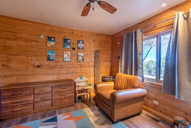 a living room with furniture and large windows
