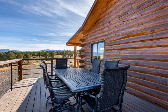 a view of a roof deck with table and chairs