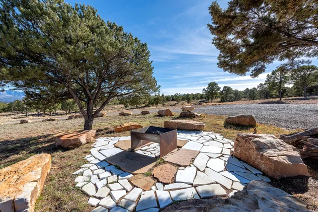 a view of a backyard with table and chairs and a fire pit