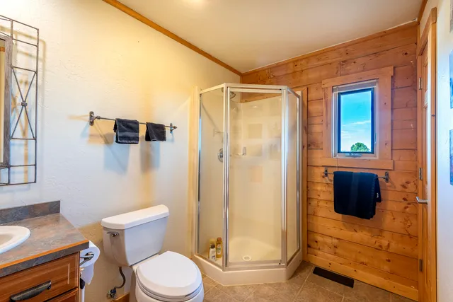 a bathroom with a toilet and a shower