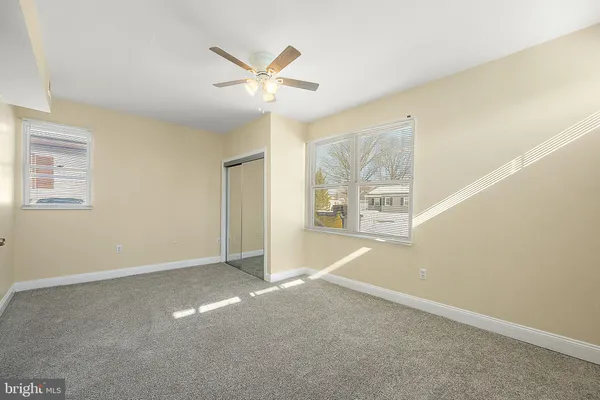 a view of a big room with wooden floor and windows in a room