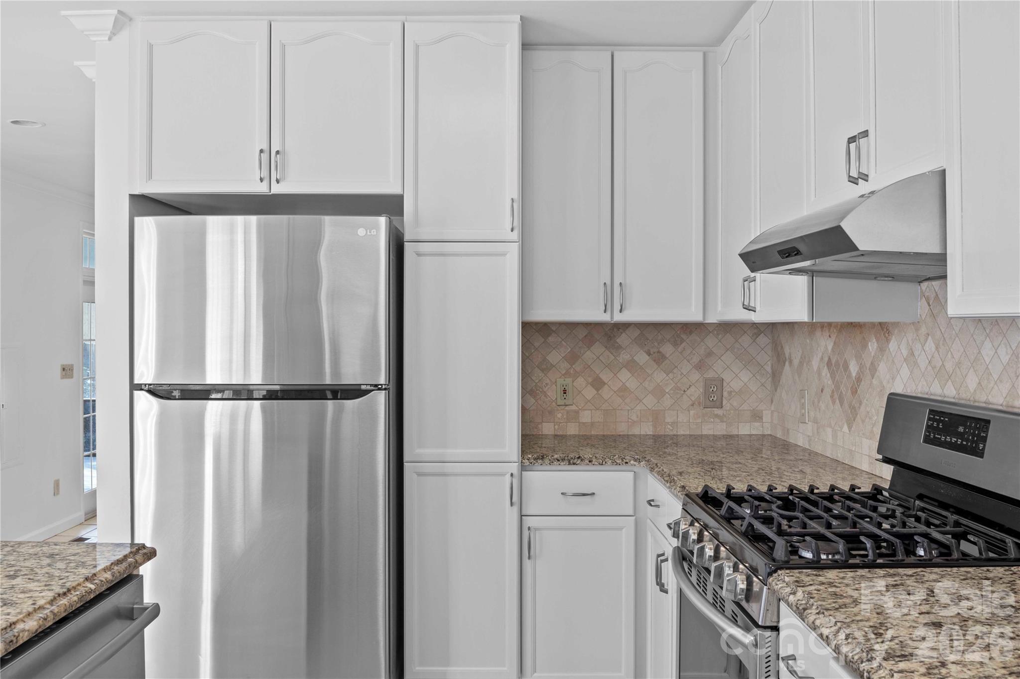 21133 Rio Oro Drive Cornelius, NC 28031 - Photo 17 of 41 a kitchen with white cabinets and white appliances