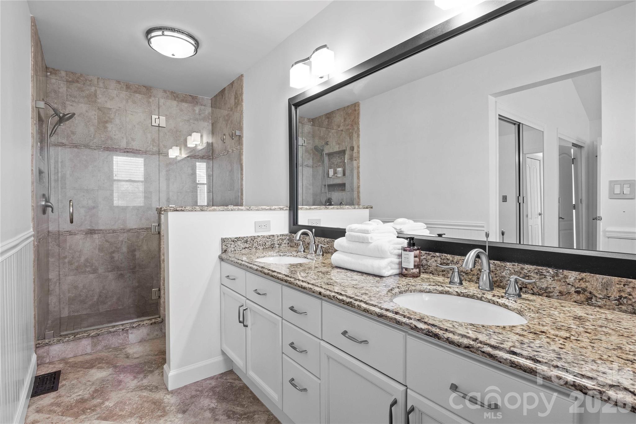 21133 Rio Oro Drive Cornelius, NC 28031 - Photo 21 of 41 a bathroom with a granite countertop double vanity sink mirror and shower