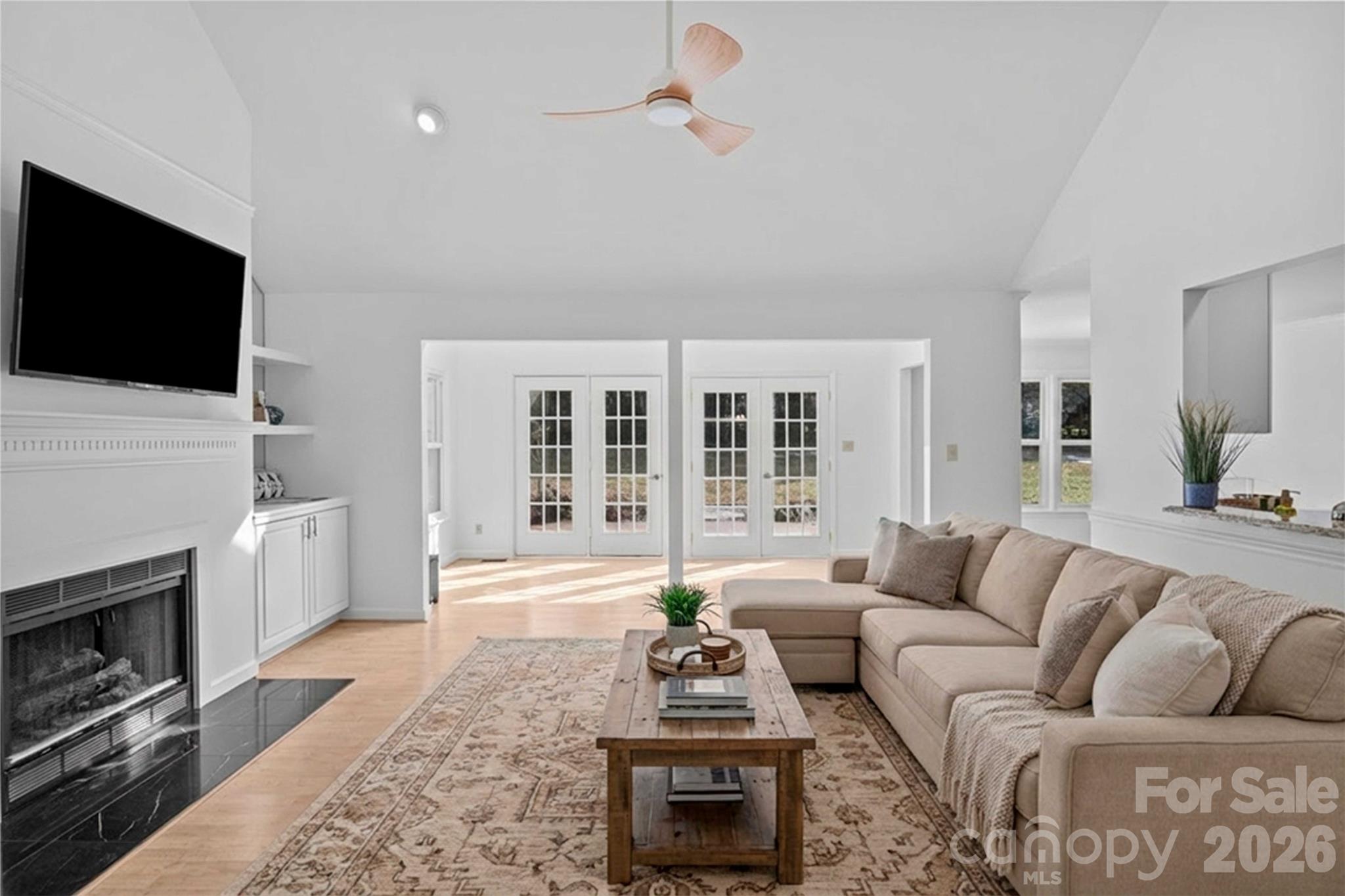 21133 Rio Oro Drive Cornelius, NC 28031 - Photo 6 of 41 a living room with furniture a flat screen tv and a fireplace