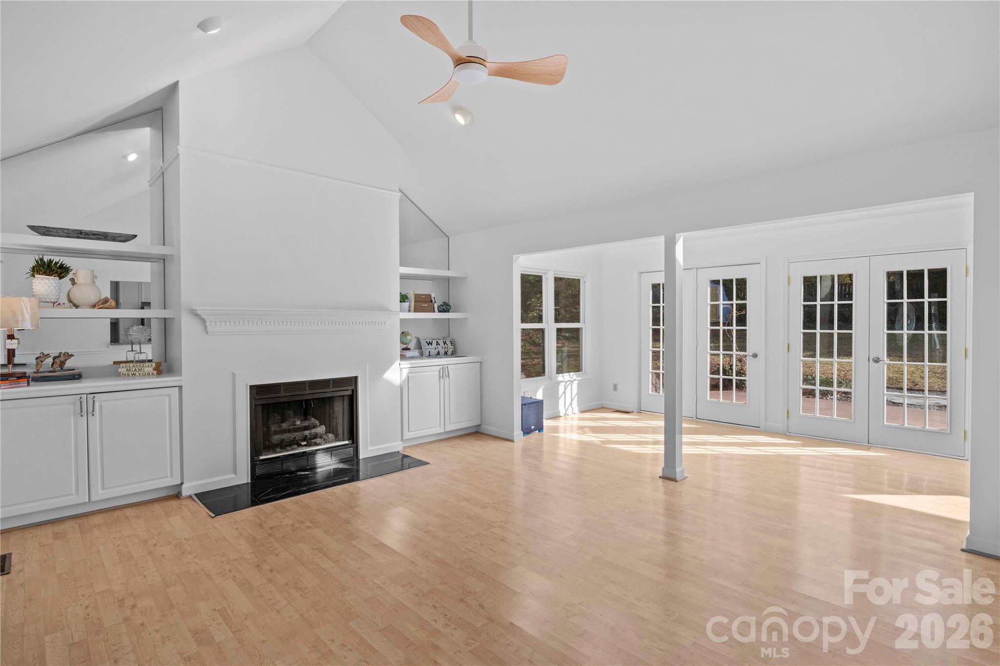 21133 Rio Oro Drive Cornelius, NC 28031 - Photo 9 of 41 a view of a livingroom with a fireplace a ceiling fan and windows