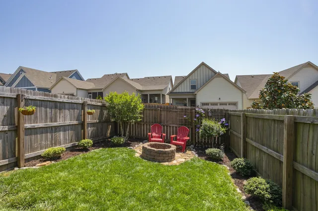 a view of a house with a yard and sitting area