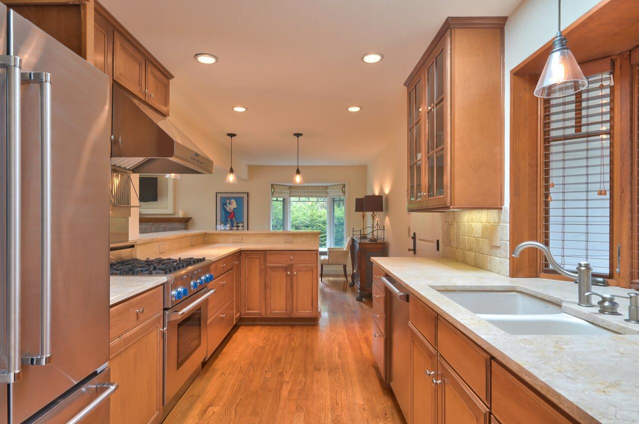 3115 Middle Ranch Road Pebble Beach, CA 93953 - Photo 5 of 15 a large kitchen with stainless steel appliances granite countertop a sink and a stove