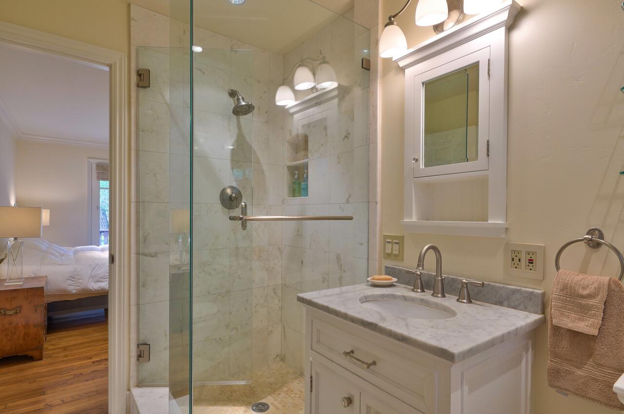 3115 Middle Ranch Road Pebble Beach, CA 93953 - Photo 9 of 15 a bathroom with a granite countertop sink mirror and a shower