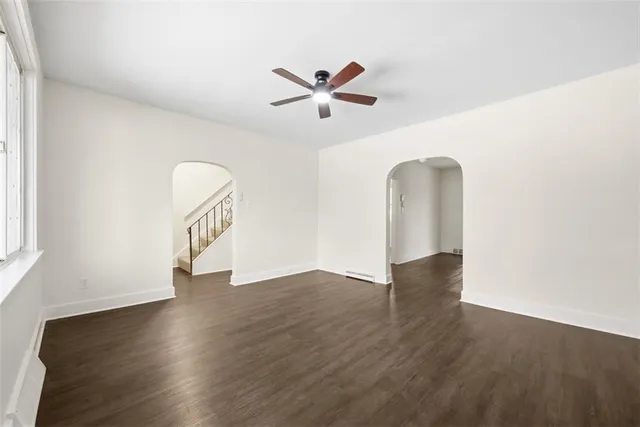 wooden floor in an empty room with a window