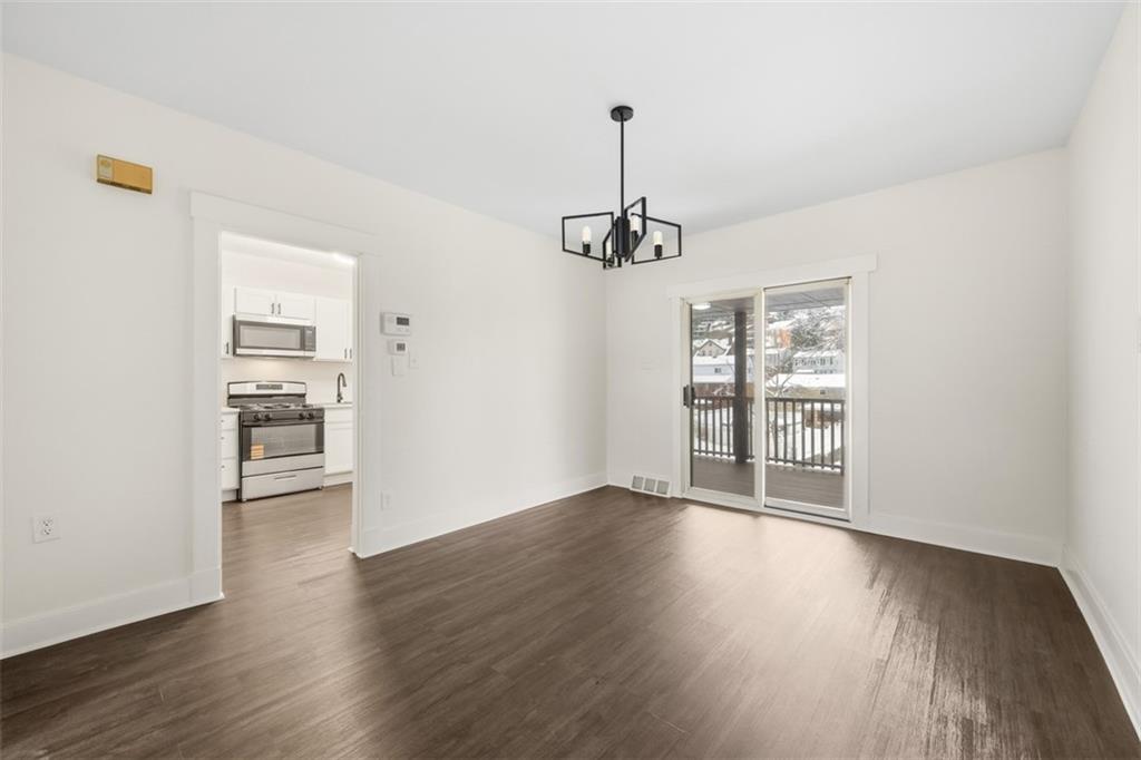 127 Duffland Street Pittsburgh, PA 15210 - Photo 13 of 36 a view of an empty room with a window and wooden floor