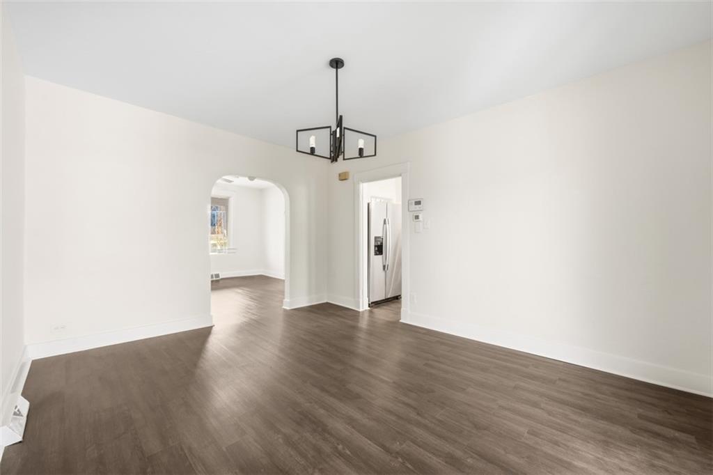 127 Duffland Street Pittsburgh, PA 15210 - Photo 14 of 36 a view of a room with wooden floor a ceiling fan and a window