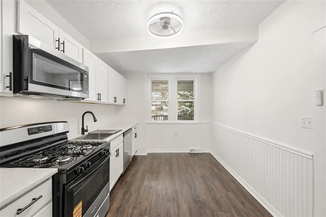 a view of a sink and a stove in a kitchen