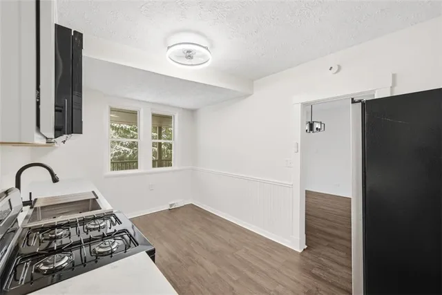 a kitchen with granite countertop a stove and a microwave