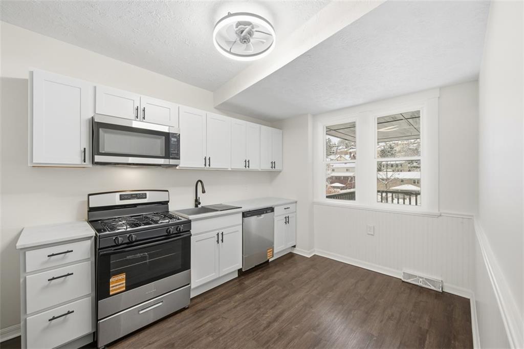 127 Duffland Street Pittsburgh, PA 15210 - Photo 17 of 36 a kitchen with granite countertop a stove and a microwave