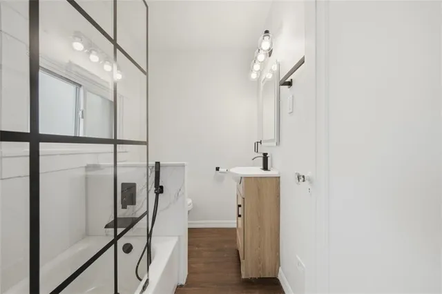 a bathroom with a sink a toilet and shower